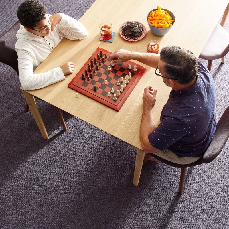 people playing chess carpeted floor Komplete Flooring Siren, WI